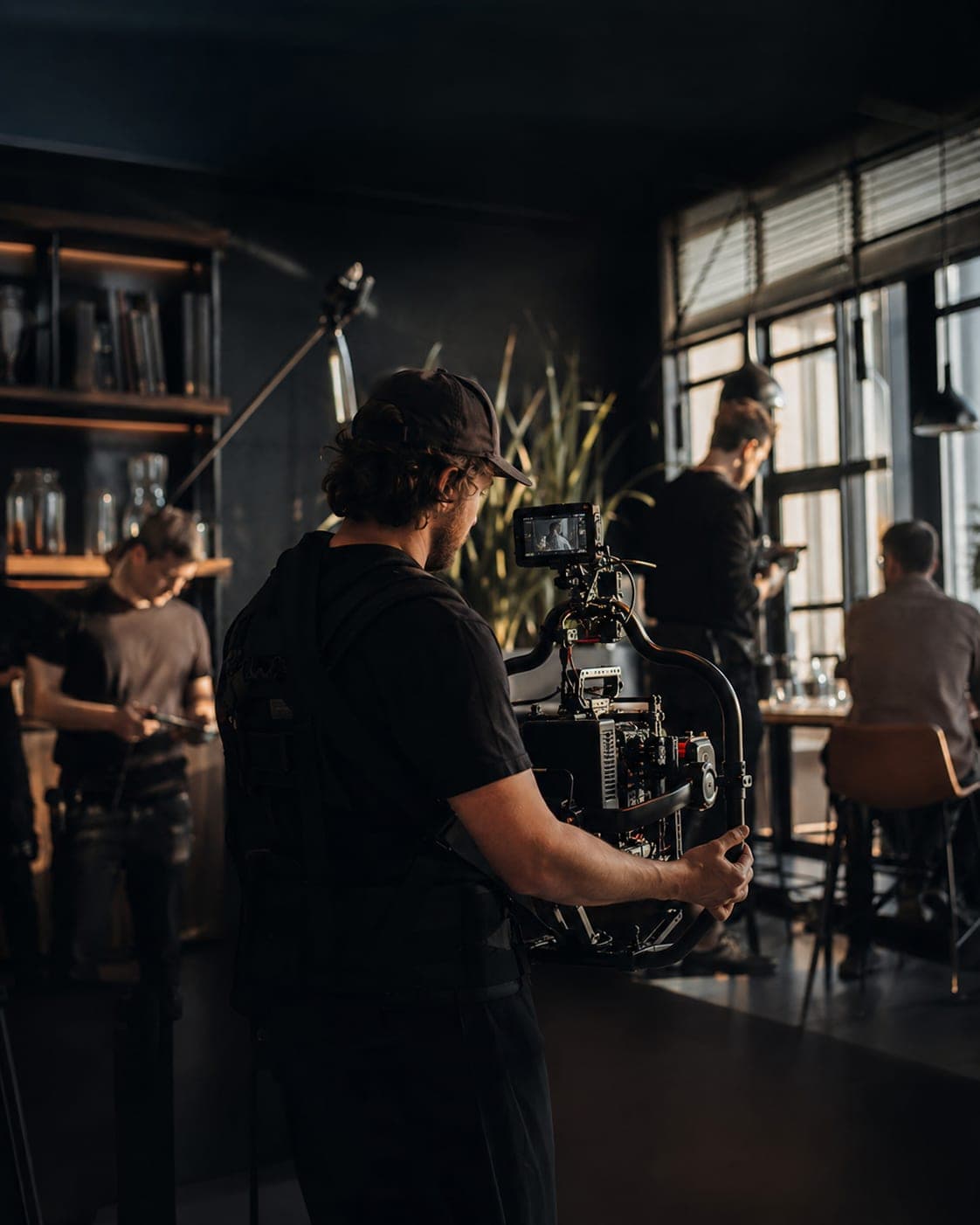 A Visual Trenz operator working a gimbal-mounted cinema camera on location.